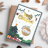 Christmas-themed scratch-off card with festive design on a white surface.