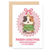 Christmas card with a guinea pig holding a Christmas tree and candy cane, surrounded by festive decorations.