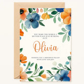 Personalized birthday card with blue and orange watercolor flowers, green foliage, and custom name in script font