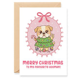 Christmas card with a cartoon dog in a green sweater and pink bow, featuring text 'Merry Christmas to my favourite hooman!'.