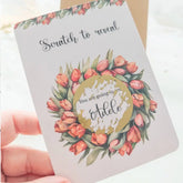 Tulip-themed scratch reveal card with gold sticker