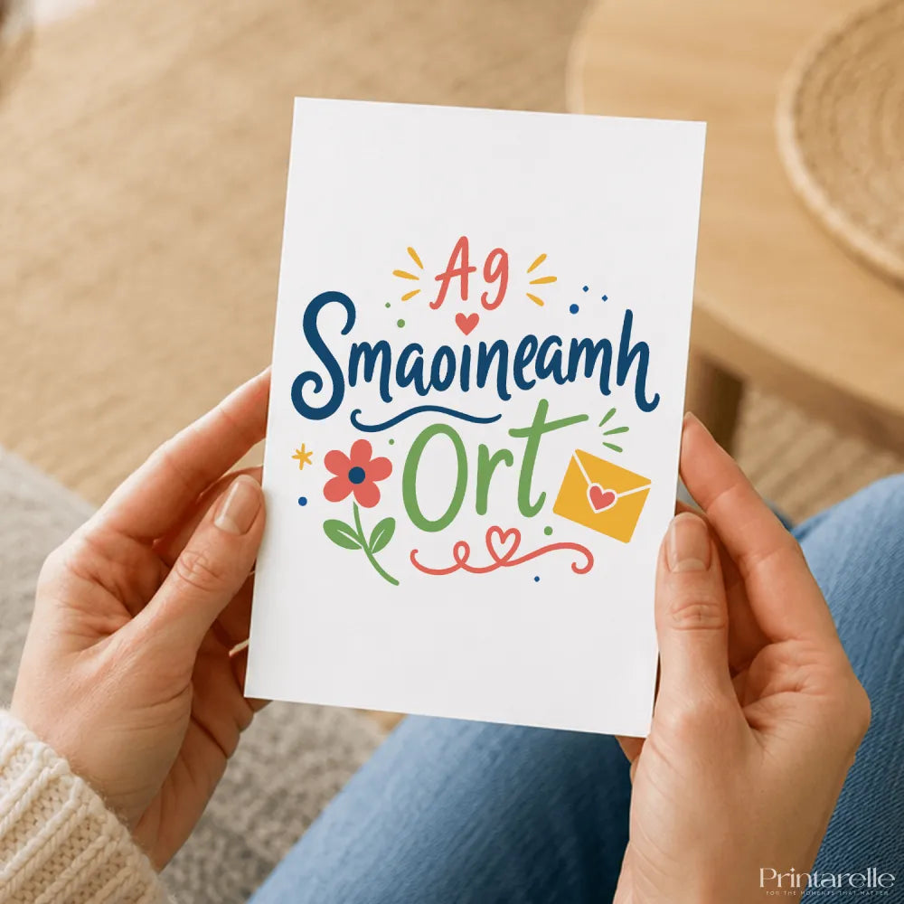 A white greeting card with colorful hand-drawn illustrated design featuring a flower and envelope for irish thinking smaoineamh ort