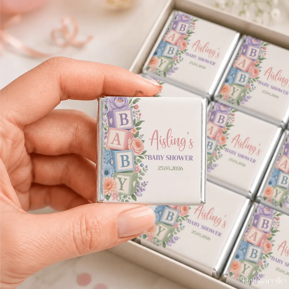 A delicate square white foil wrapped mini neapolitan chocolate with pastel floral design for aisling baby shower