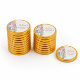Golden chocolate coins with personalized baby shower labels featuring floral designs and alphabet blocks