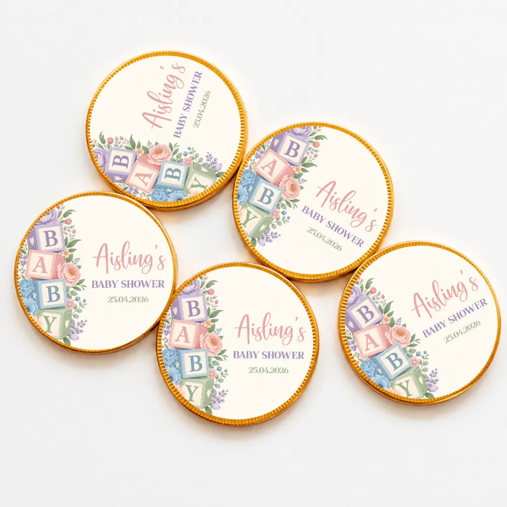 Round gold-edged chocolate coins with pastel baby shower alphabet blocks design on cream centers