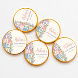 Round gold-edged chocolate coins with pastel baby shower alphabet blocks design on cream centers