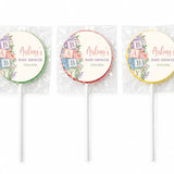 Three colorful baby shower lollipop favours with pastel floral alphabet blocks design on white sticks for alphabet blocks shower