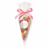 A clear cellophane sweet cone filled with colorful gummy candies tied with a pink satin bow for an alphabet blocks shower