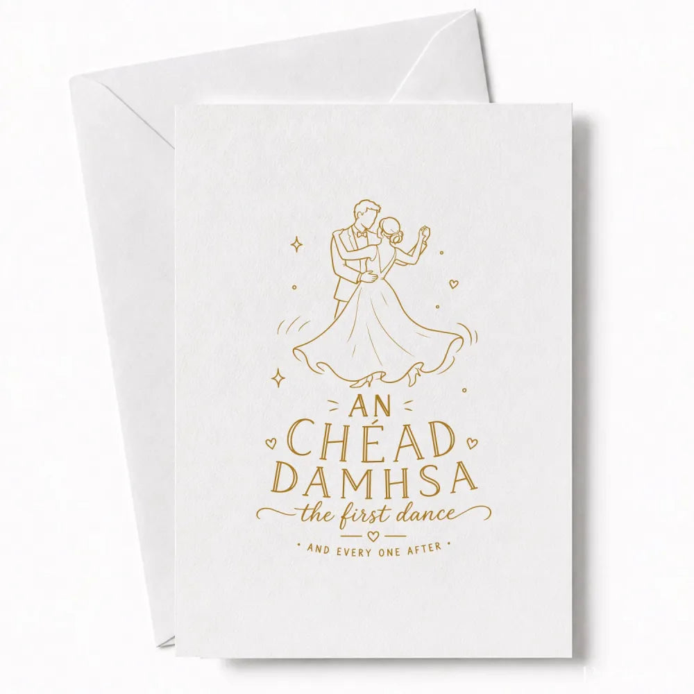 A white wedding card with gold foil couple dancing illustration and an chéad damhsa text for wedding day cards