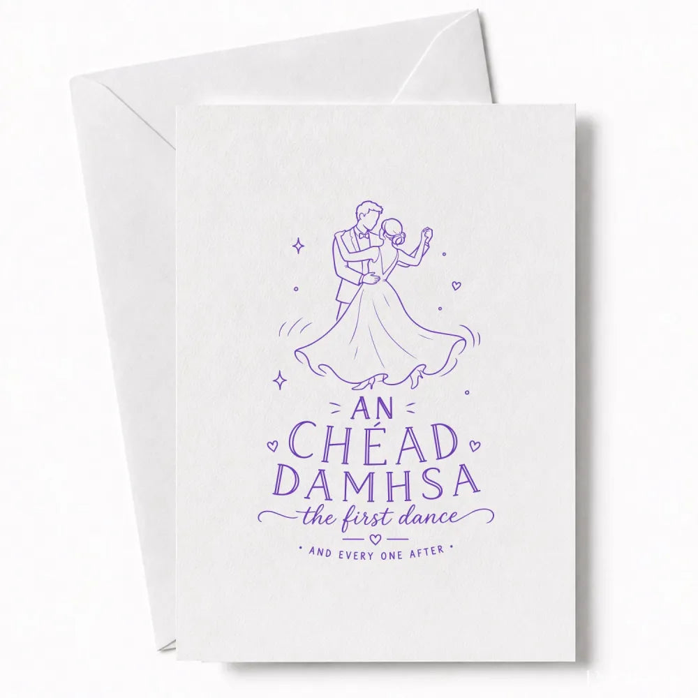 A white wedding card with a delicate purple drawing of a couple dancing and an chéad damhsa text for wedding day cards