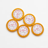 Golden milk chocolate coins 40mm with pink floral designs and personalised confirmation labels for emilys day
