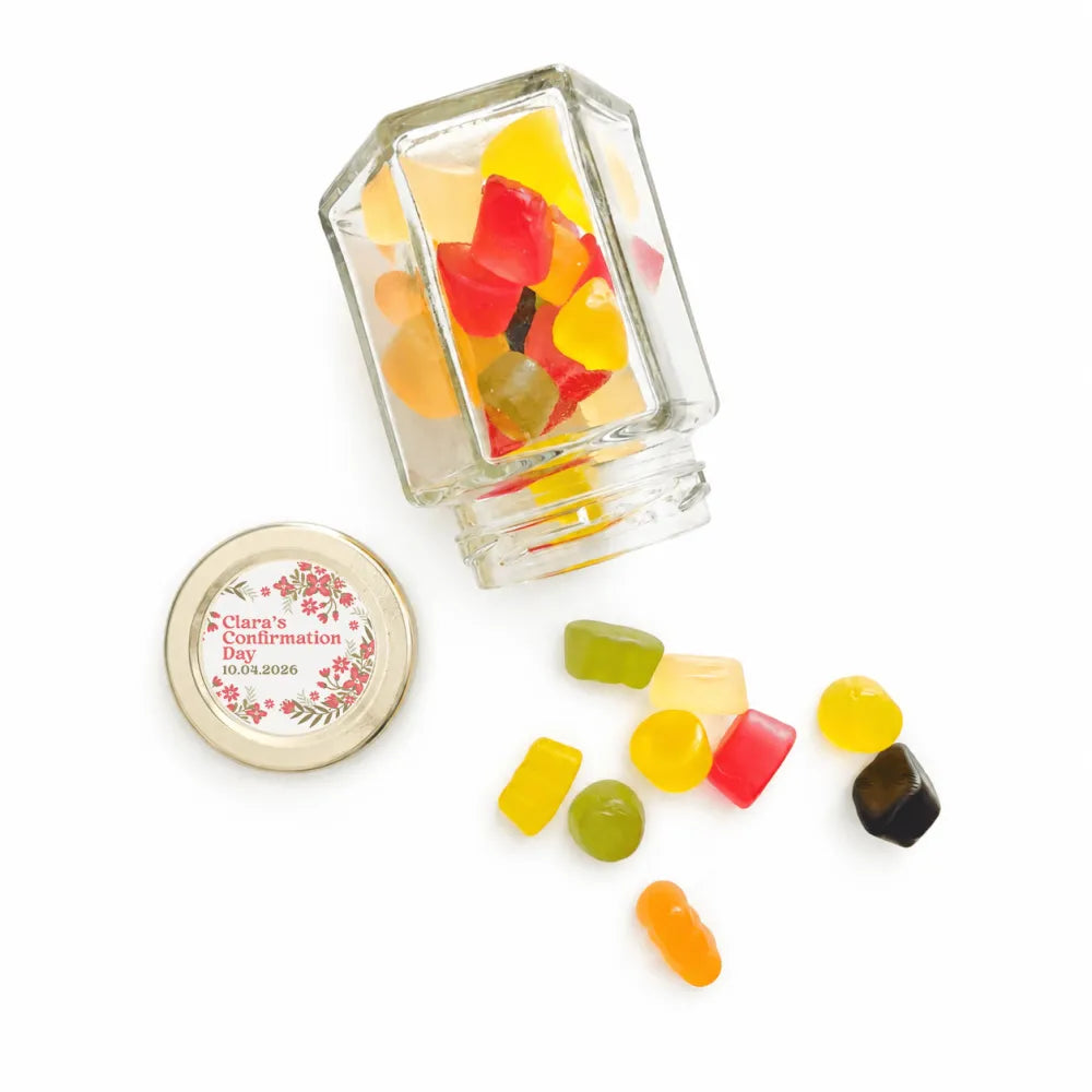 Clear glass hex jar with 48mm pale gold twist lid and personalised sticker printed filled with colorful gummy candies