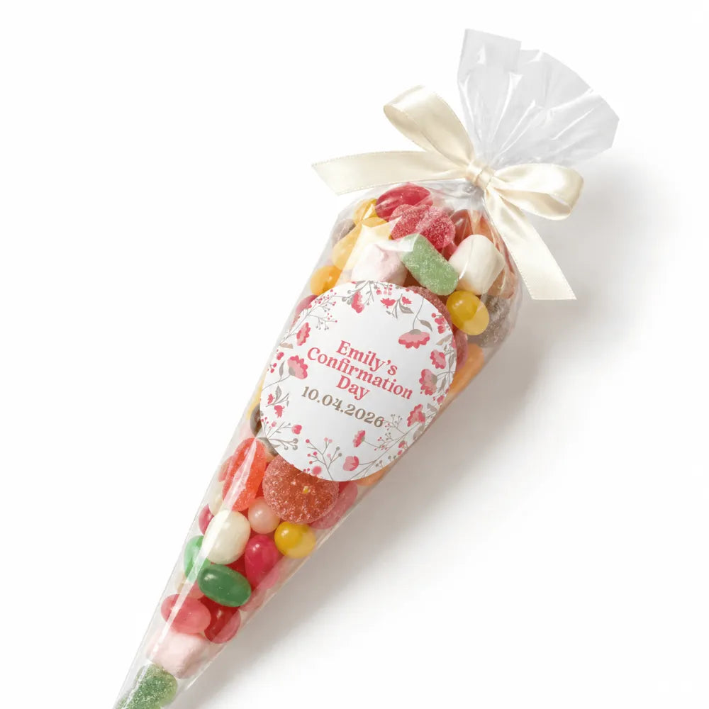 A clear plastic personalised sweet cone filled with colorful gummy candies and marshmallows tied with cream ribbon
