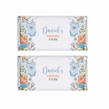 Two personalised 40g chocolate bars wrapped in silver foil with blue babygrow and floral labels for christening