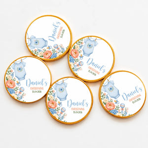 Round milk chocolate coins with gold edges featuring a blue babygrow design and personalized text for daniels christening