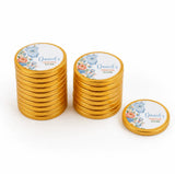 Golden milk chocolate coins with a white floral label featuring daniel’s christening and a blue babygrow design