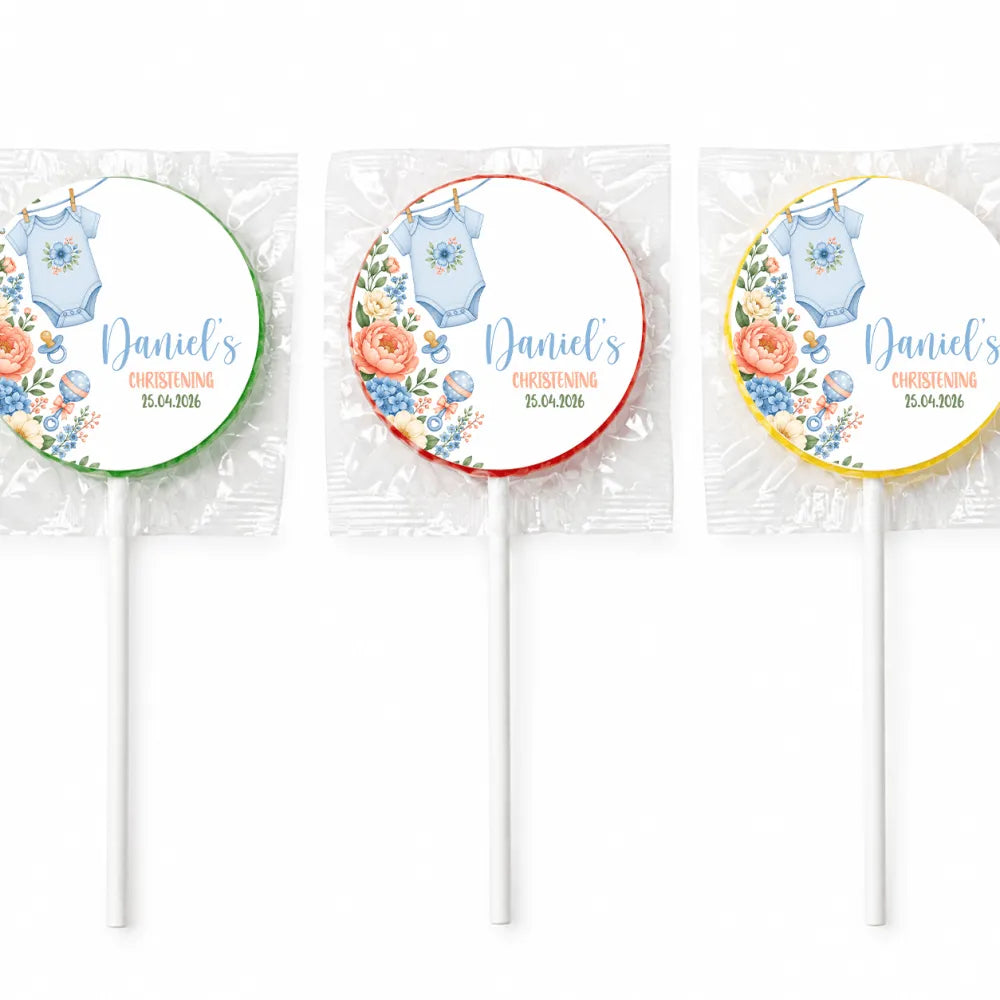 Three personalized round lollipop favours with blue onesie babygrow design and daniel’s christening details