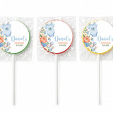 Three personalized round lollipop favours with blue onesie babygrow design and daniel’s christening details