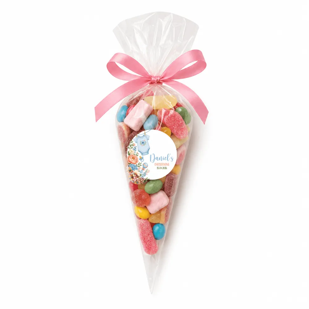 A clear cellophane sweet cone filled with colorful gummies tied with pink ribbon and blue onesie themed label