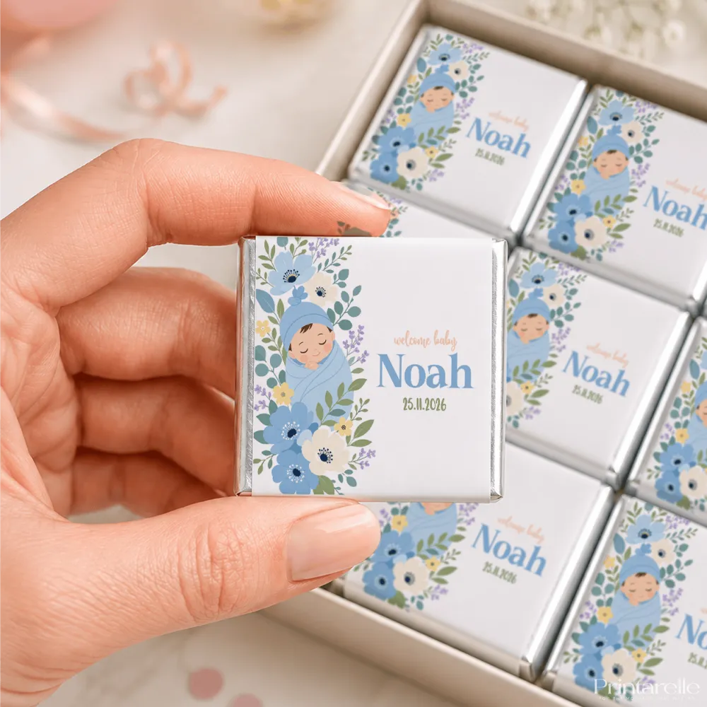 A personalized white chocolate mini neapolitan wrapped in silver foil with blue floral design and a baby named noah