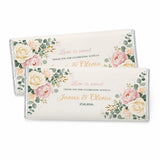 Two personalised 40g chocolate bars wrapped in silver foil with blush peony floral design for weddings