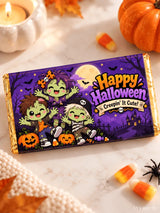 A 100g halloween chocolate box wrap in purple and gold with cartoon zombie kids pumpkins bats and happy halloween text
