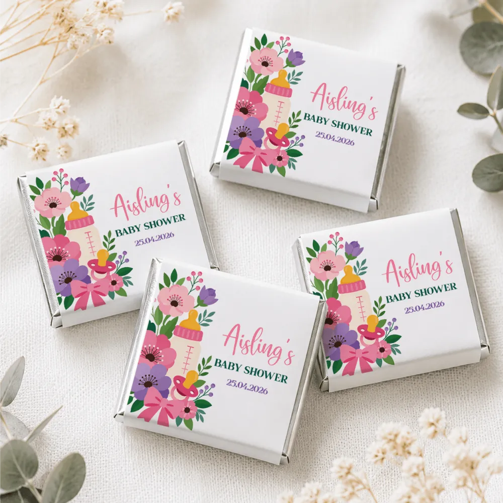White chocolate mini neapolitan chocolates in colorful floral and baby-themed boxes with pink flowers and a pacifier design