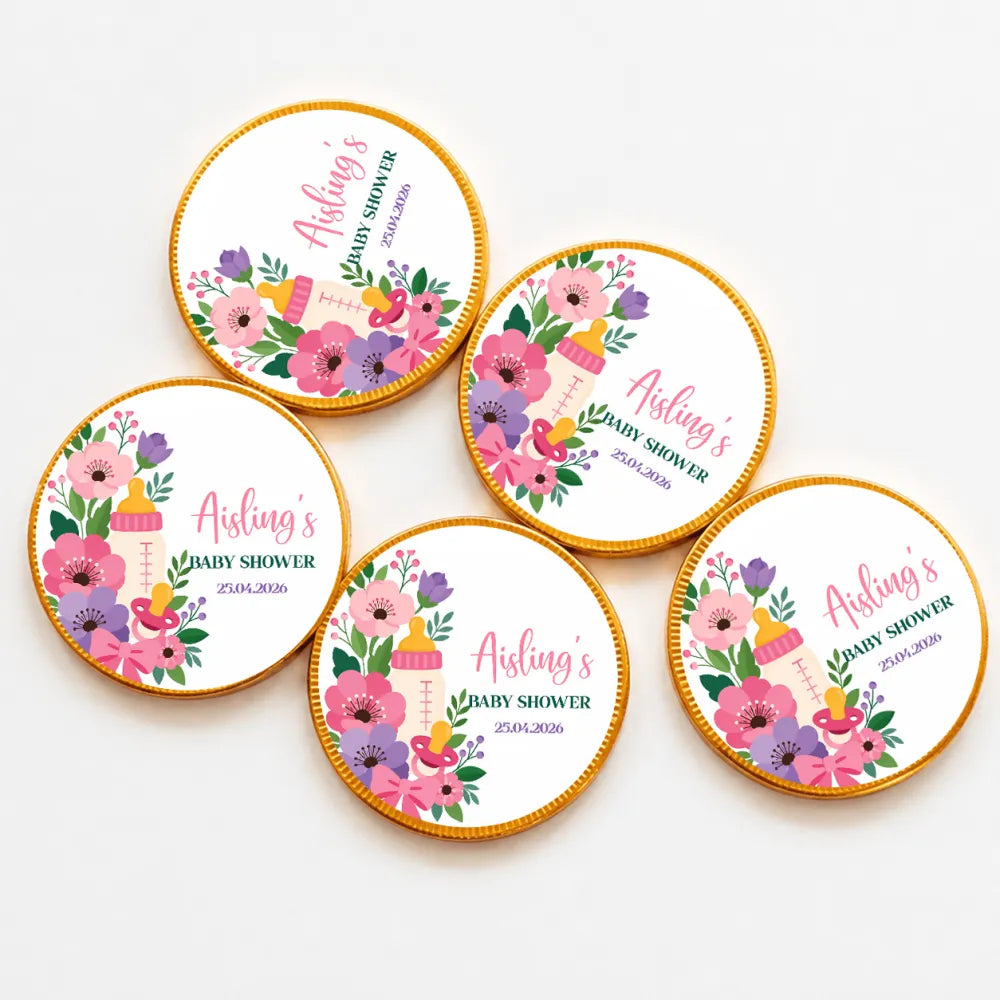 Round gold-edged milk chocolate coins with pink purple floral design and baby bottle for baby shower favor