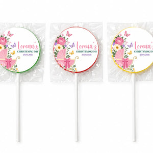 Three personalized pink swirl lollipop favours wrapped in cellophane for butterfly pram christening favors