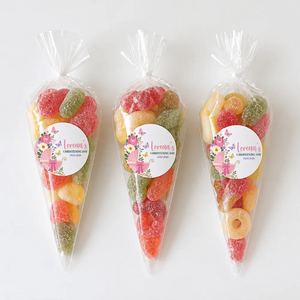 Three clear plastic sweet cones filled with colorful fizzy sweets with butterfly pram christening labels