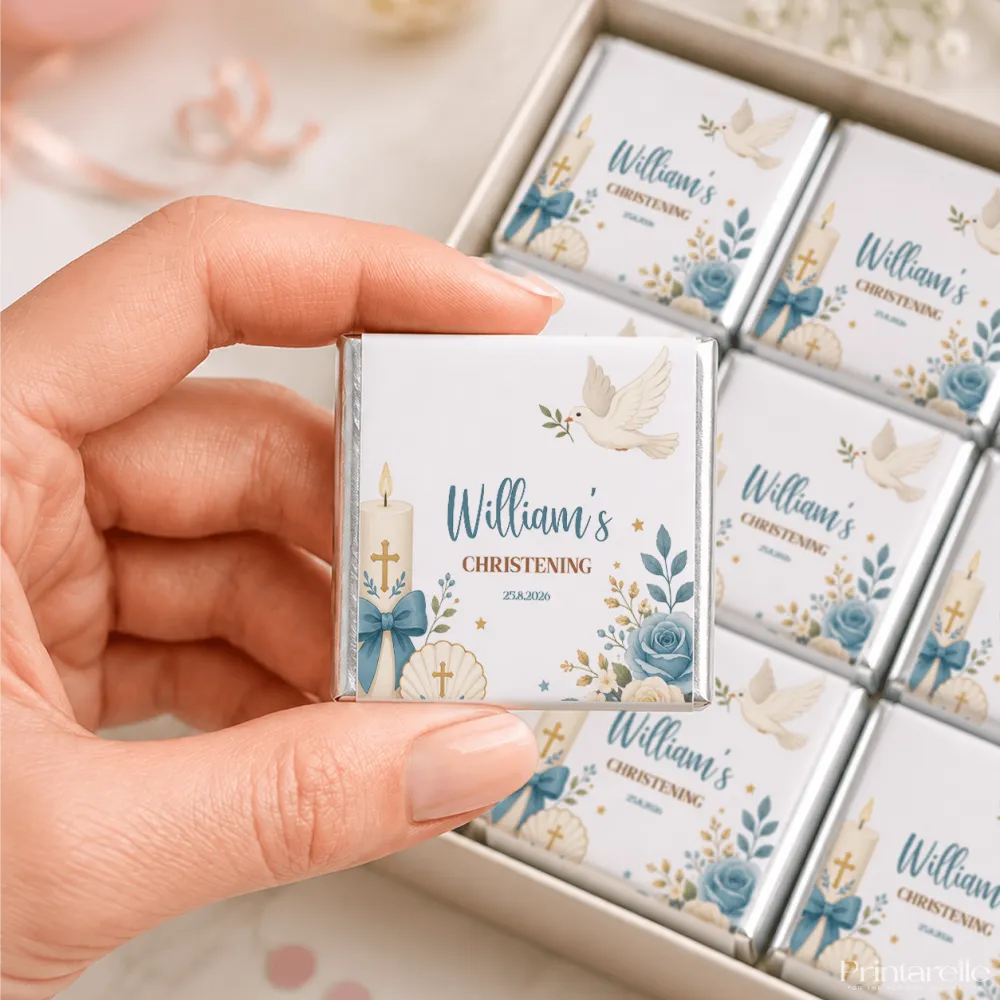 A white chocolate square with blue and gold dove, candle, and floral design from candle and shell christening loose wrapped mini neapolitans