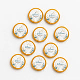Round gold rimmed coasters with white center blue floral dove design featuring william’s christening and 40mm milk chocolate coins