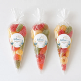 Three colorful sweet cones with shell design filled with assorted gummy candies for christening celebrations