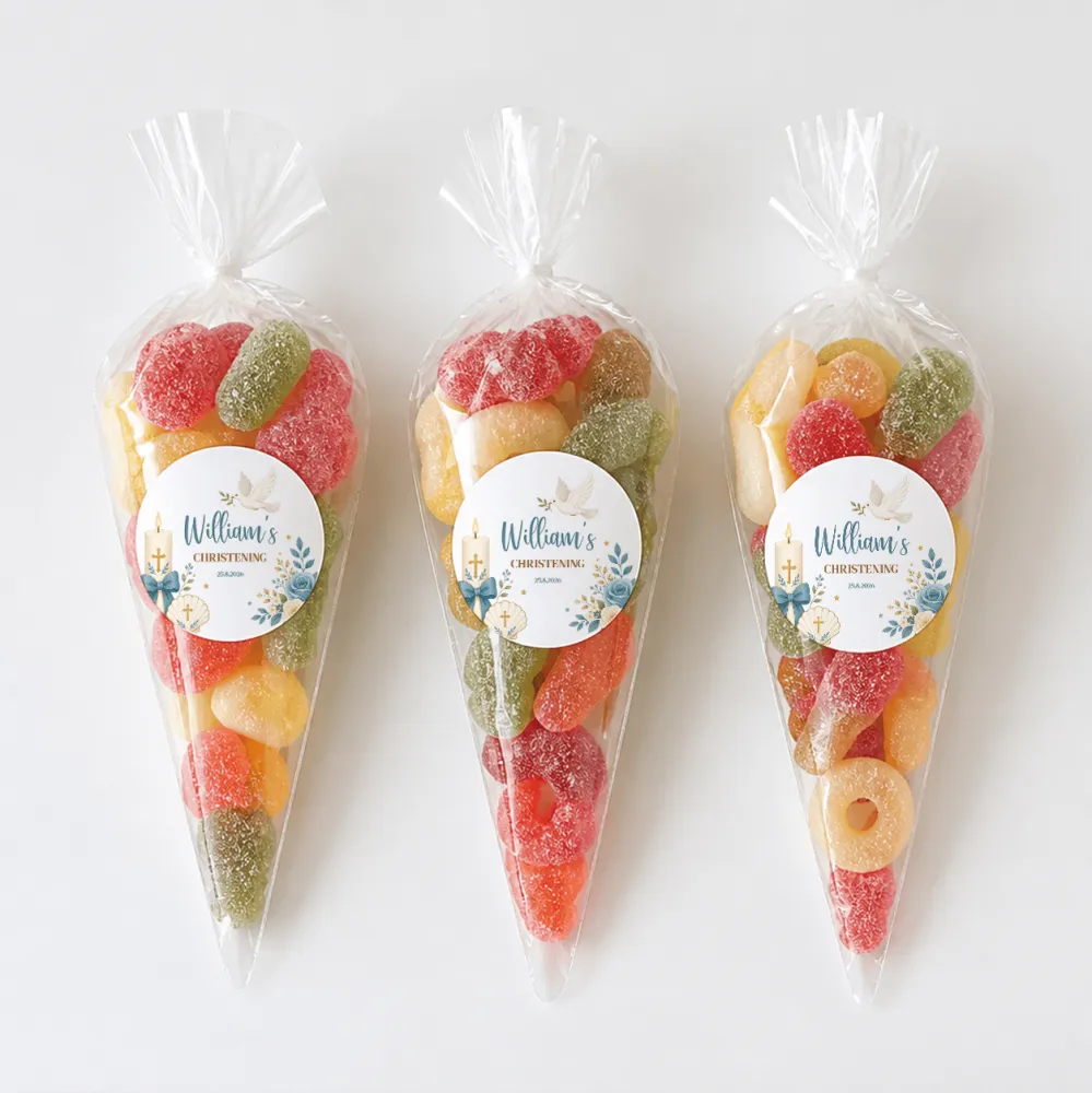 Three colorful sweet cones with shell design filled with assorted gummy candies for christening celebrations