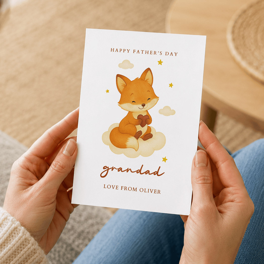 Person holding a Father's Day card with a fox illustration and personalized text.