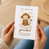 Person holding a Father's Day card with a monkey illustration and text.