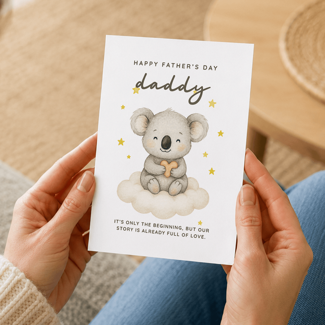 Person holding a Father's Day card with a koala illustration and text.