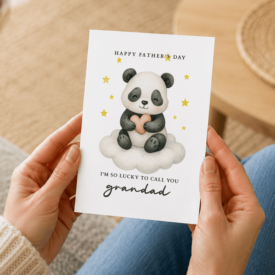 Person holding a Father's Day card with a panda illustration and text.