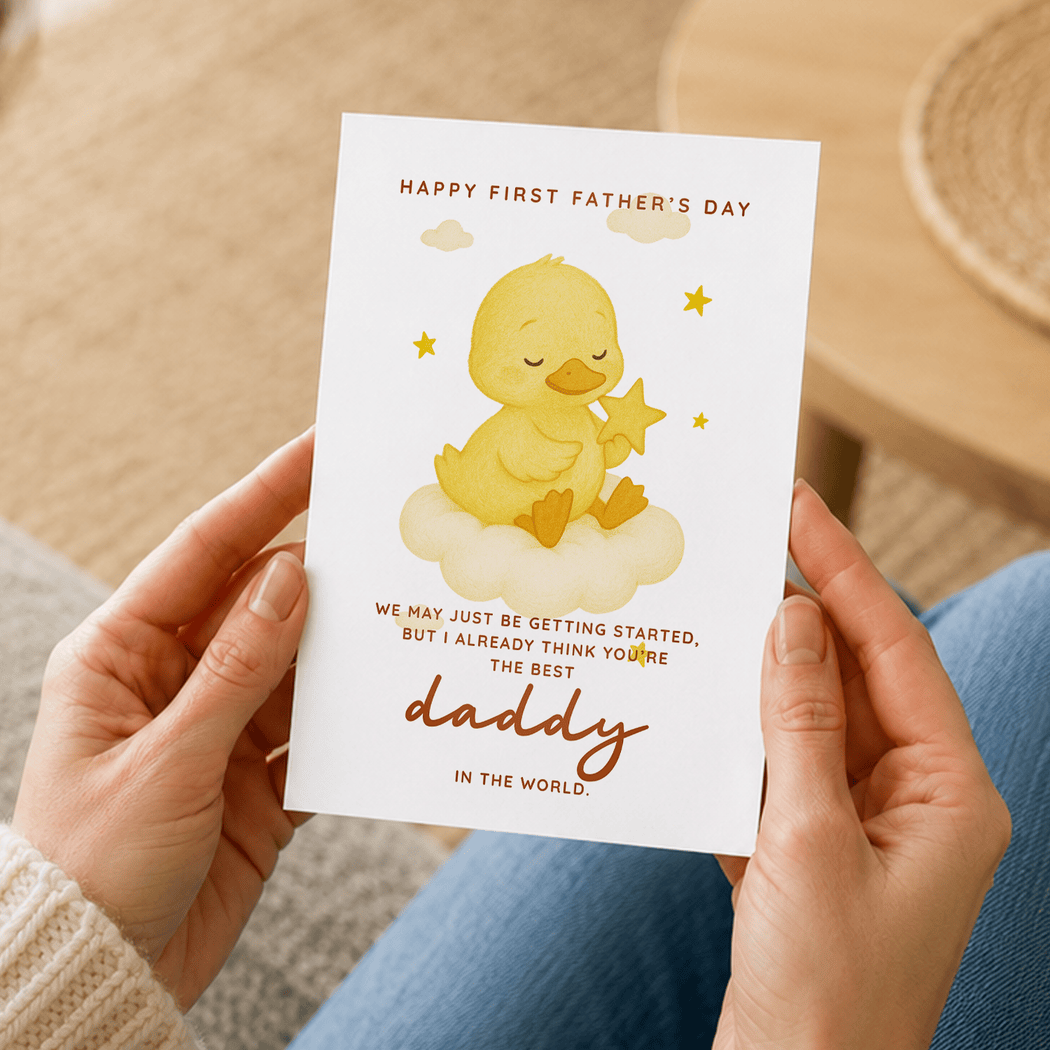 Person holding a Father's Day card with a yellow duck illustration and text.