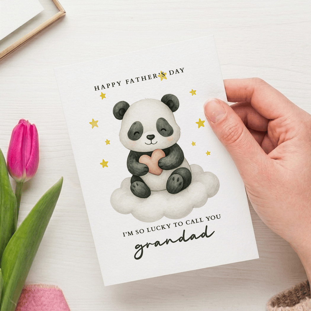 Hand holding a Father's Day card with a panda illustration and pink tulip on a white background