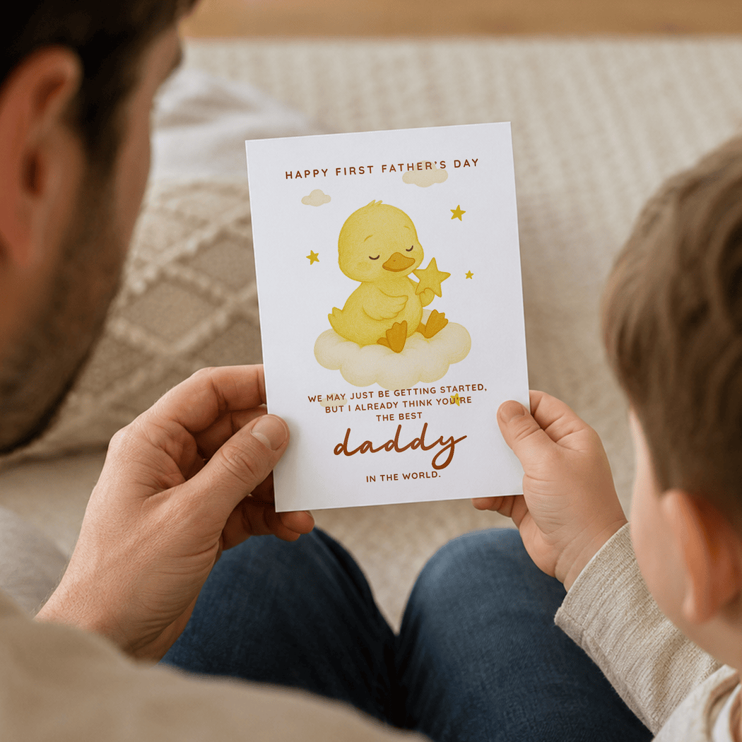 Person holding a Father's Day card with a yellow duck illustration and text.