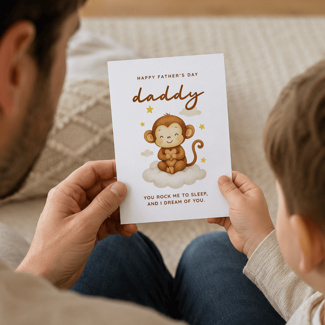 Child holding a Father's Day card with a monkey illustration and text.