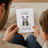 Person holding a Father's Day card with a panda design and text.