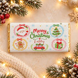 Personalised kids chocolate bar wrap with white chocolate in gold foil featuring festive christmas illustrations and merry christmas emily text