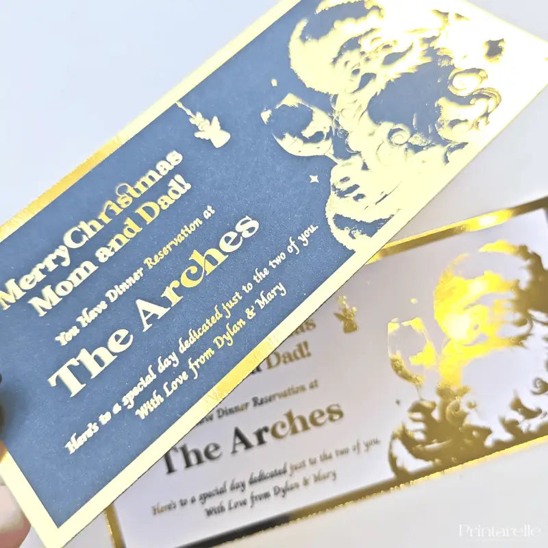 Gold-foil invitation cards with text and decorative elements on a white background