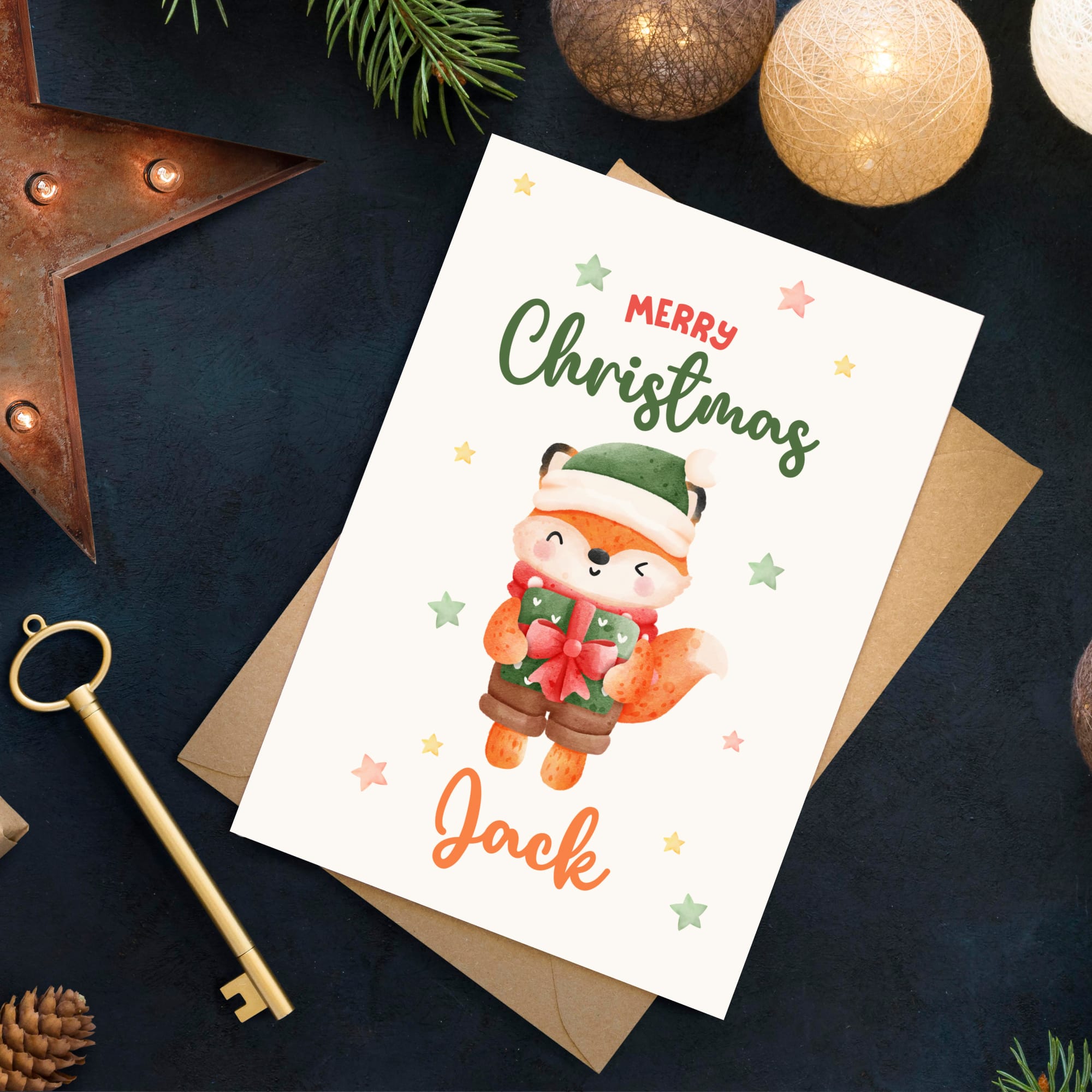 Christmas card with a fox illustration and 'Merry Christmas Jack' text on a dark surface with festive decorations.