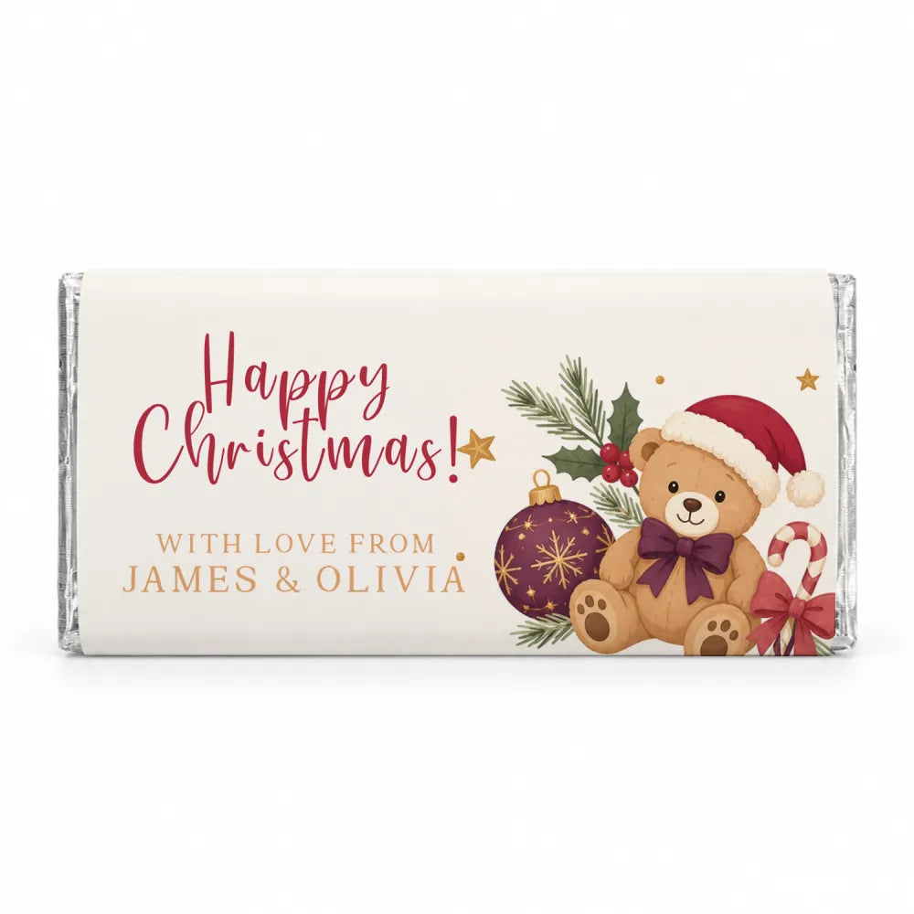 A festive white chocolate bar wrapped in silver foil with a tan teddy bear and holiday ornaments personalised 40g