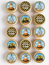 Construction 4th birthday cupcake toppers with orange cones yellow dump trucks on wafer paper icing sheet background