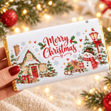 A festive white chocolate bar with a cosy cottage and snowman christmas chocolate bar wrap in gold foil