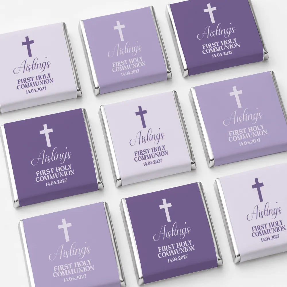 Purple and lavender foil wrapped mini neapolitan chocolates with white cross and script text for holy communion favors